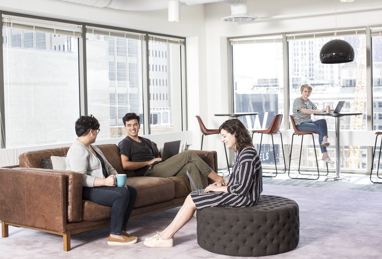 Employees working in a common lounge at Civis's Chicago office