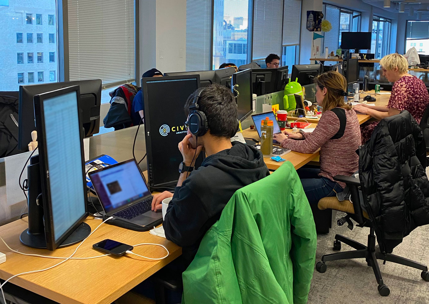 Employees working at computers, photo shot from behind