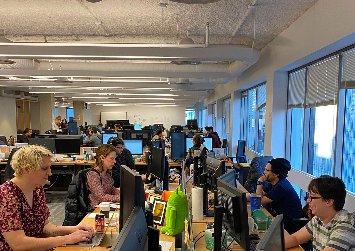 Office full of employees working together in an open office floor plan