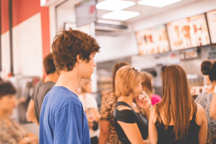 Group of young people in the lobby of a QSR