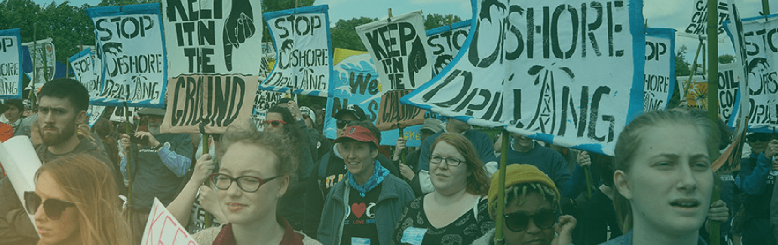 A photo of a group of protesters holding signs while marching