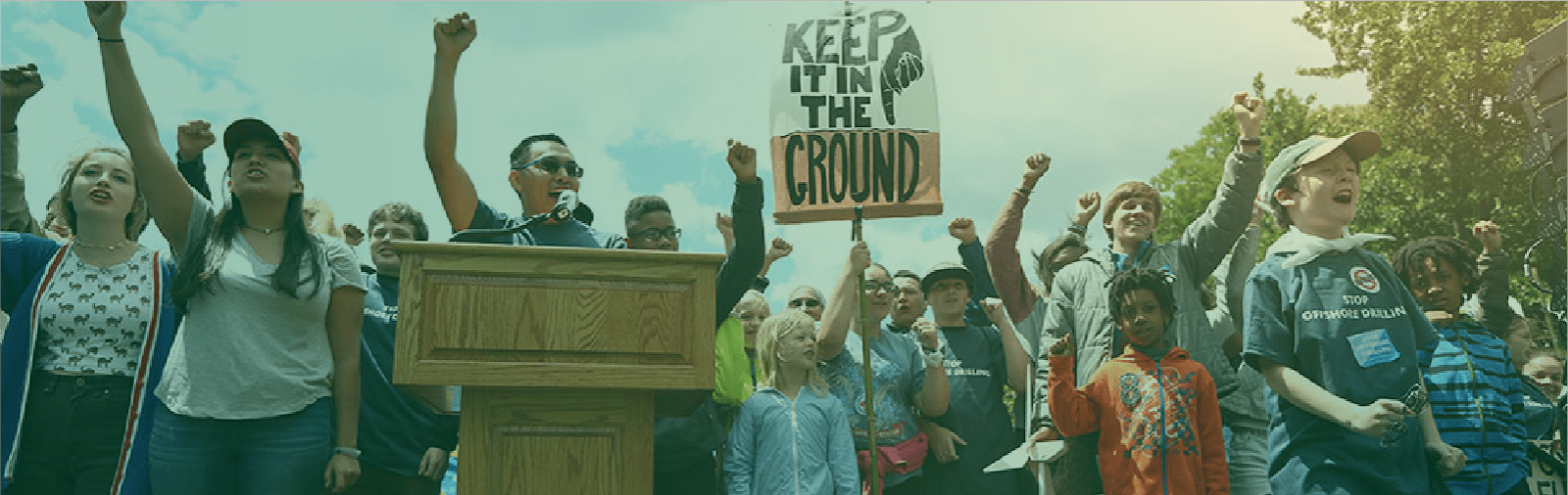 A photo of someone at a lectern addressing a crowd