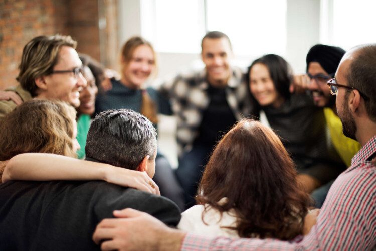 People with joined hands as a team